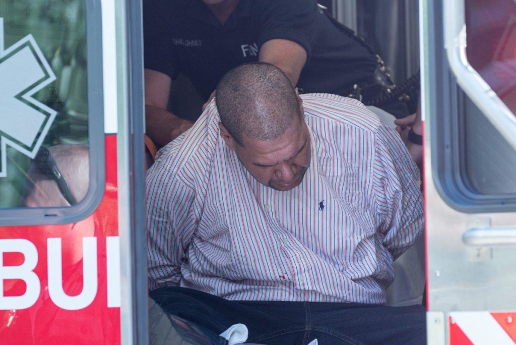 The man who stole the yellow cab seen handcuffed inside an ambulance