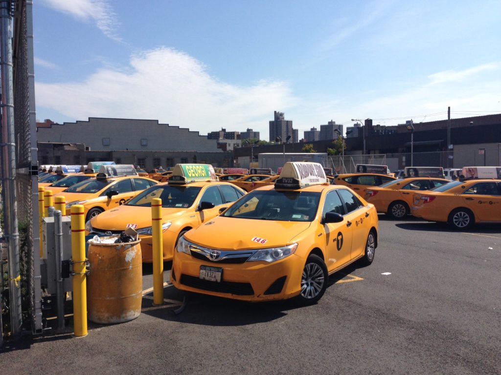 Rows of yellow cabs parked in a Queens lot