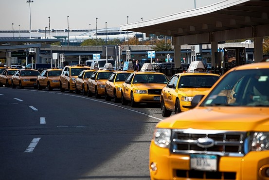 Line of yellow taxis at the JFK Airport terminal taxi stand