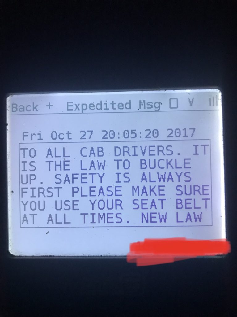 Taxi meter screen message reminding cab drivers to wear seat belts