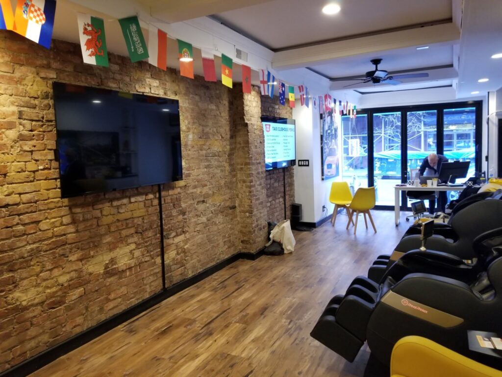 Taxi Clubhouse driver lounge with massage chairs and a TV